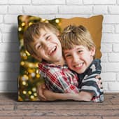 Personalised cushion featuring a printed photo of two smiling children