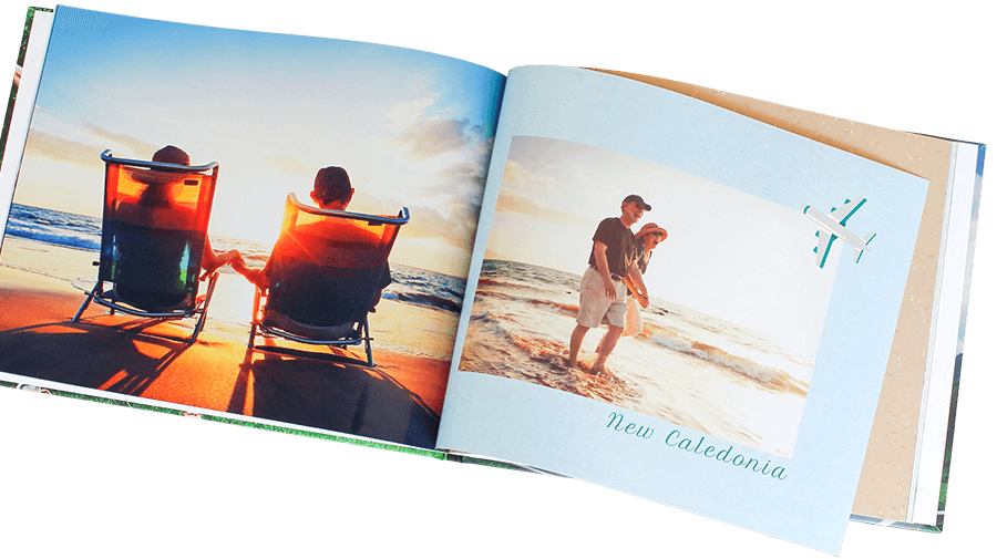 Personalised holiday photo book with silk pages open on a table.