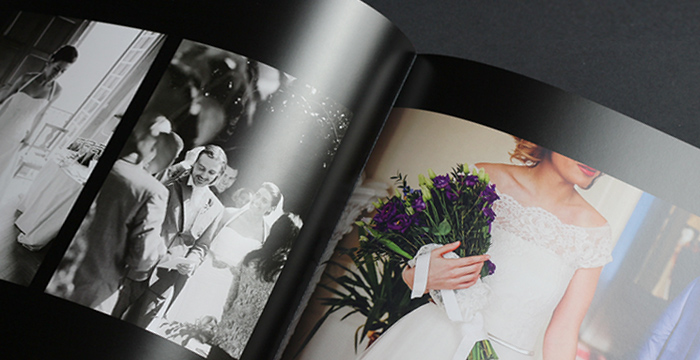 Silk finish photobook open to wedding images, showcasing high-quality print and binding.